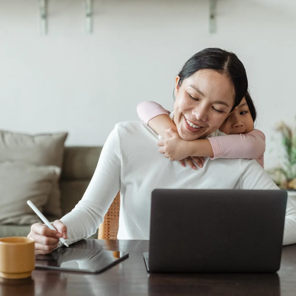 Mom Hugged by her daugther while working